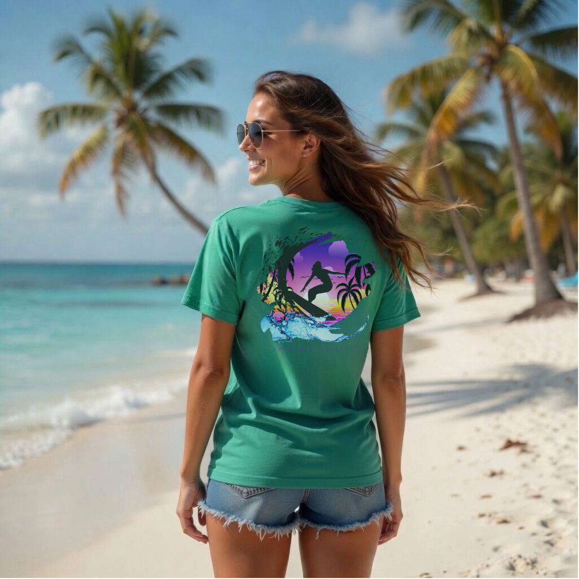 Shell Hash Republic Neon Comfort Colors T-Shirt with a retro purple sunset surfer graphic on the back, worn by a woman on a beach