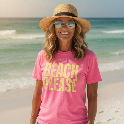 Woman wearing a Shell Hash Republic 32 t-shirt with Beach Please text, straw hat, and sunglasses on a beach