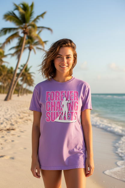 Shell Hash Republic Neon Comfort Colors T-Shirt with Forever Chasing Sunsets graphic, worn by a woman on a beach