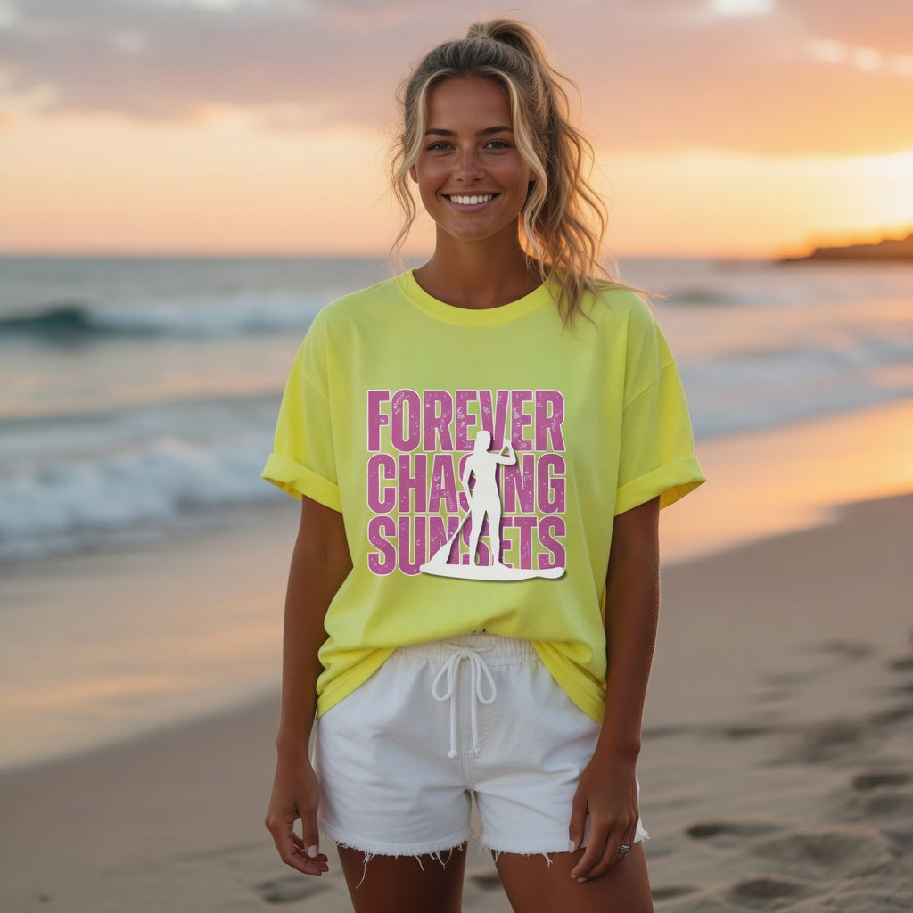 Shell Hash Republic Neon Comfort Colors T-Shirt with Forever Chasing Sunsets graphic, worn by a woman on a beach at sunset